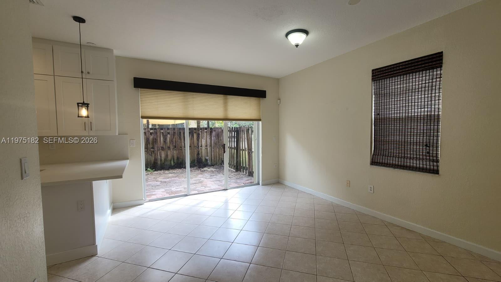 12842 Southwest 134th Street Miami, FL 33186 - Photo 7 of 22 a view of an empty room with a fireplace