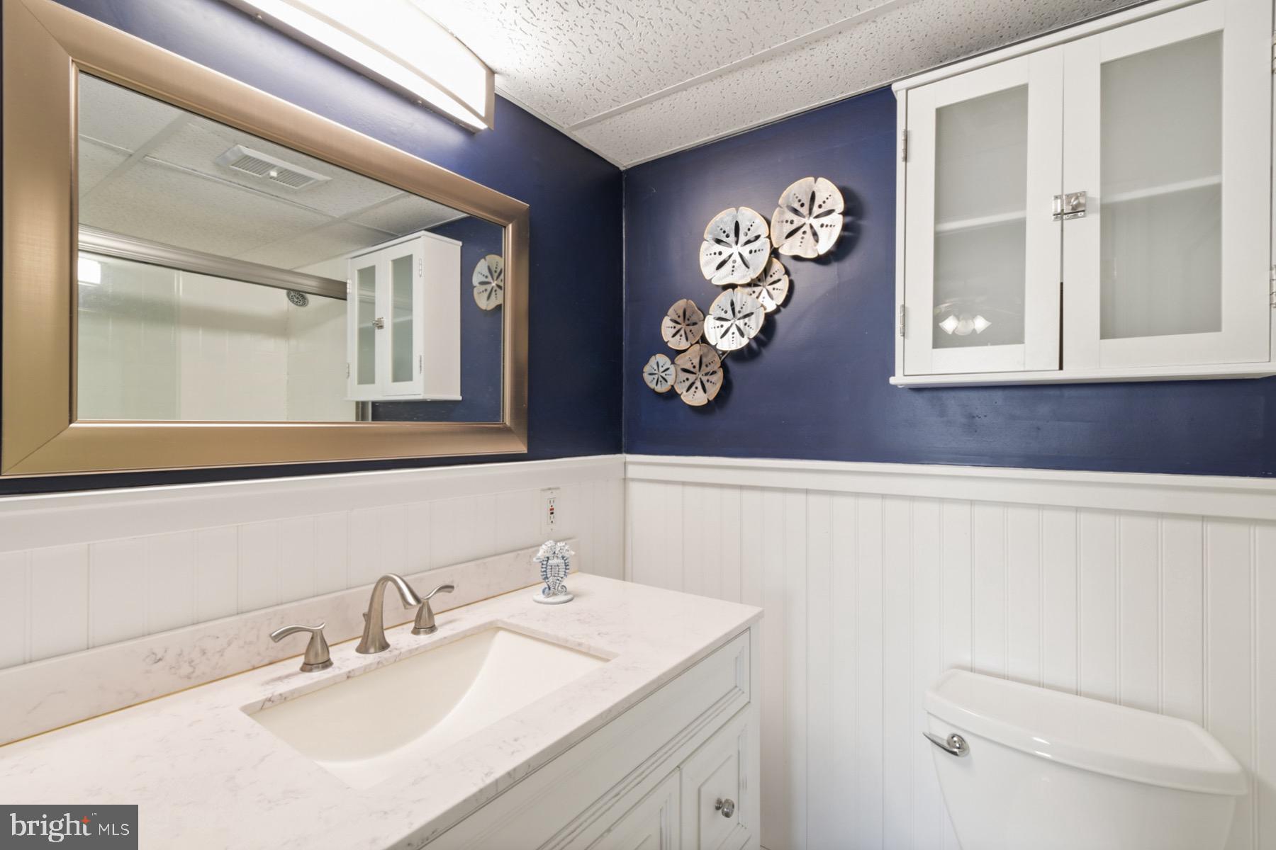 722 Mooring Road, Unit A104 Ocean City, MD 21842 - Photo 19 of 33 a bathroom with a sink and a mirror