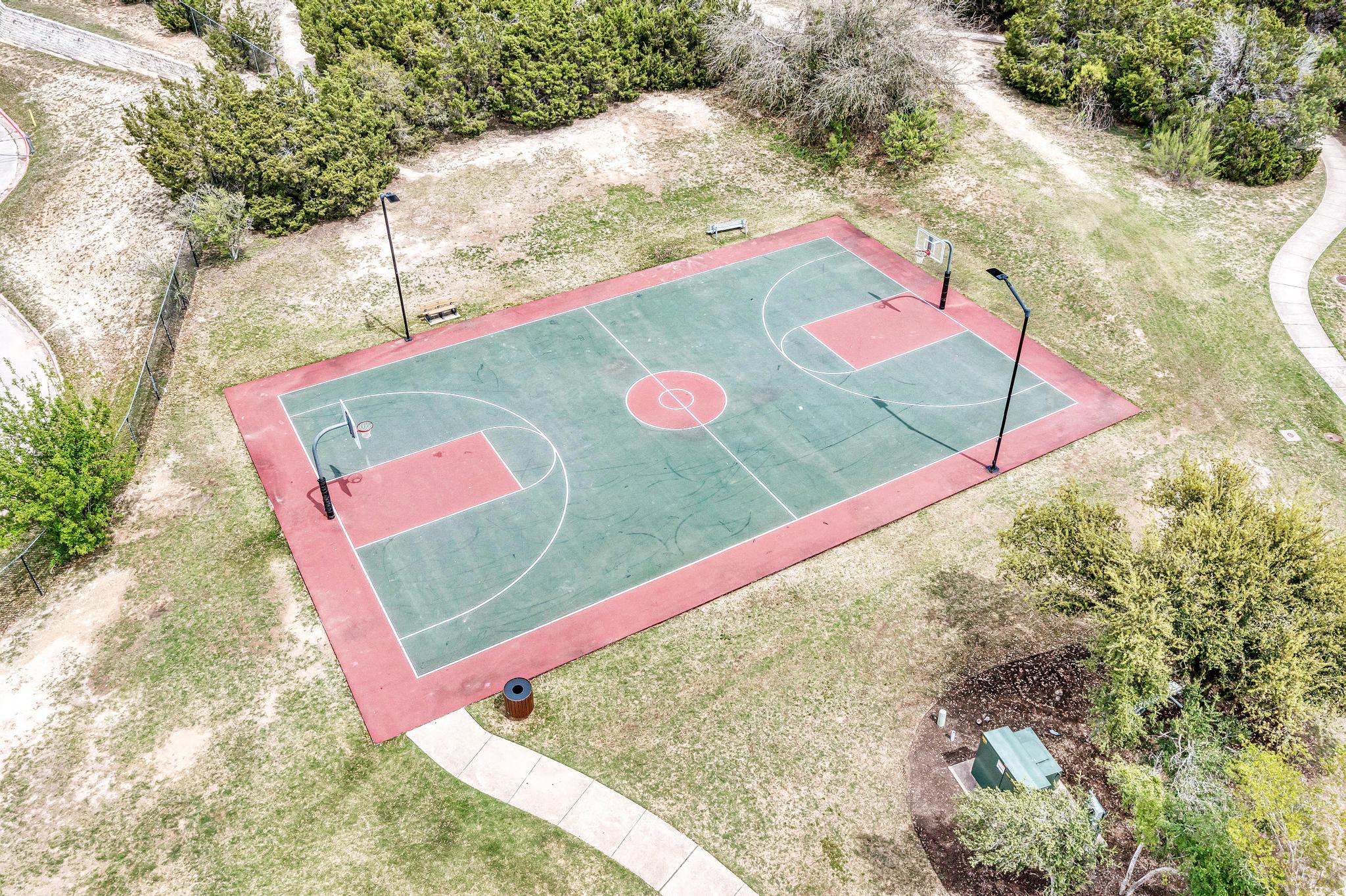 2601 North Quinlan Park Road, Unit 506 Austin, TX 78732 - Photo 39 of 39 An open-air basketball court awaits, perfect for outdoor recreation and community enjoyment.