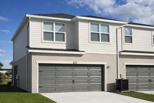 a bathroom with a double vanity sink and mirror with shower