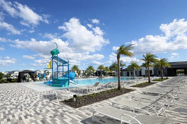 a view of a house with swimming pool and a yard