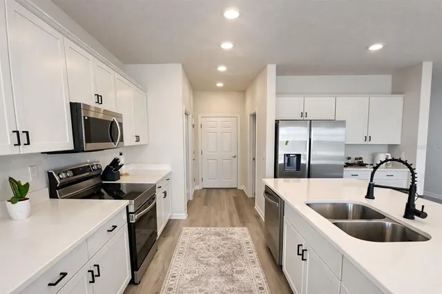 a view of a patio with a dining table and chairs with wooden floor