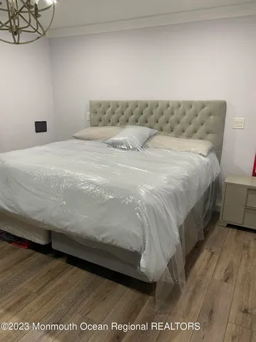 a bedroom with a bed and a night stand