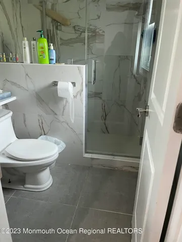 a white toilet sitting next to a bathroom sink