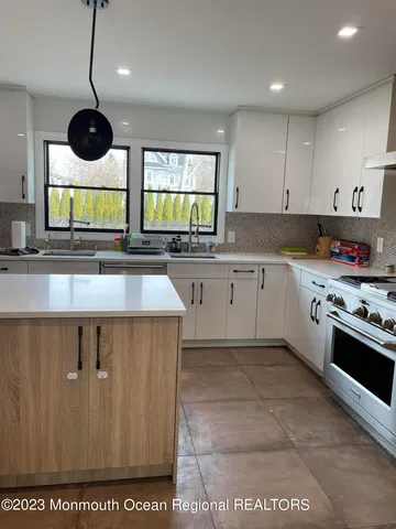 a kitchen with stainless steel appliances granite countertop a sink and a stove