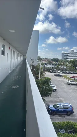 a view of a lake with a lot of cars parked on the roadside