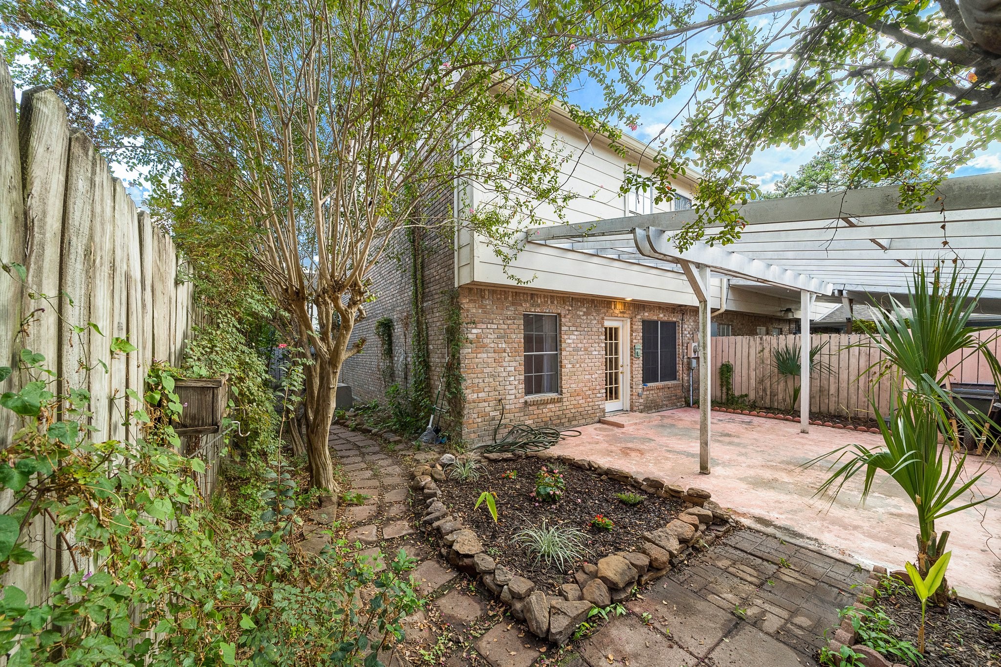 17116 Beaver Springs Drive, Unit 7 Houston, TX 77090 - Photo 2 of 14 a front view of a house with a patio