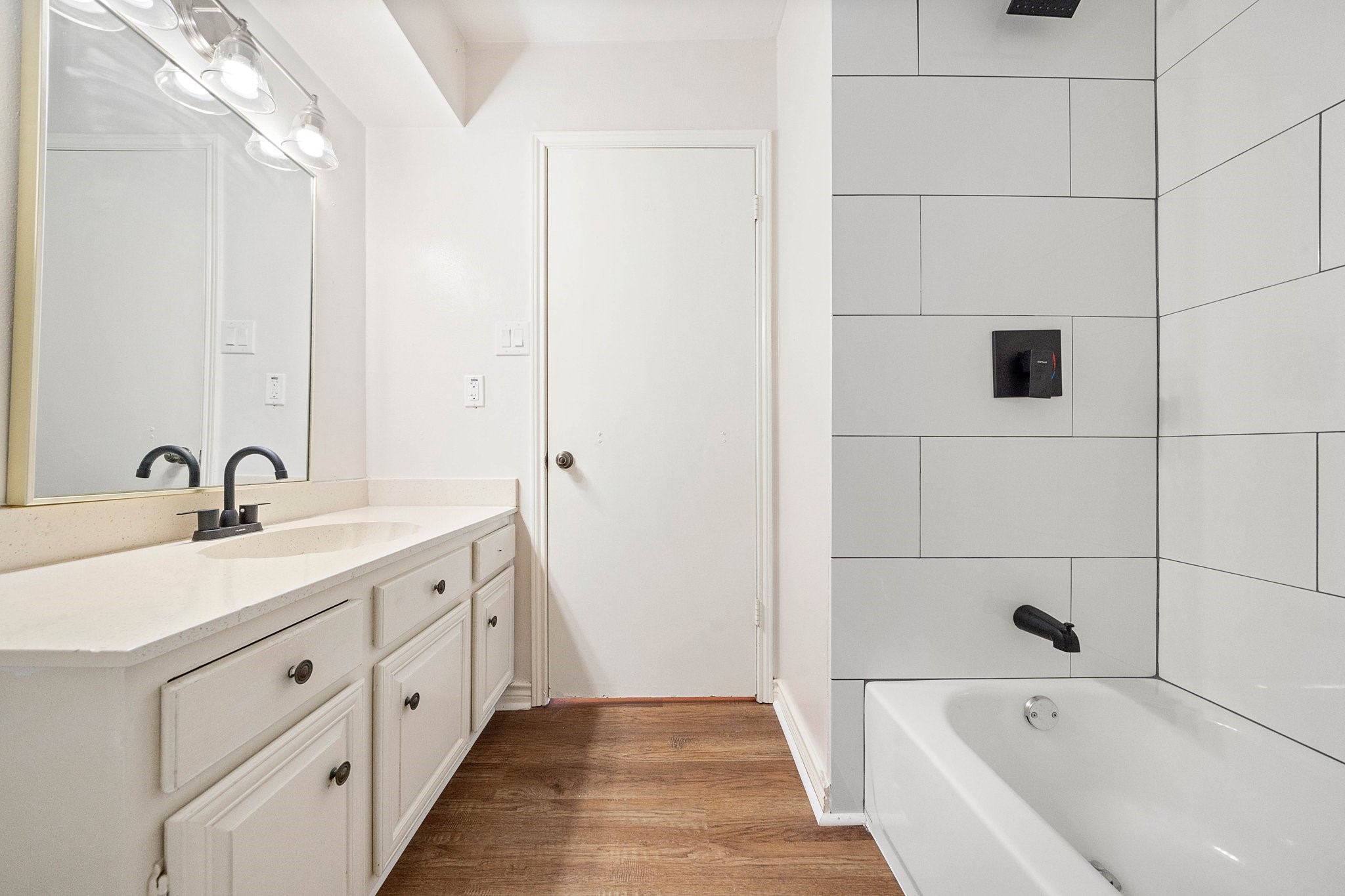 17116 Beaver Springs Drive, Unit 7 Houston, TX 77090 - Photo 8 of 14 a bathroom with a tub sink and mirror