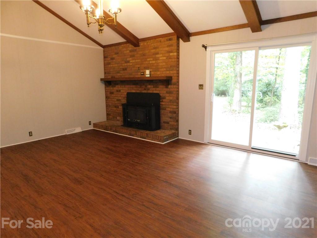 2136 Sunset Road Charlotte, NC 28216 - Photo 20 of 34 a view of empty room with wooden floor and fireplace