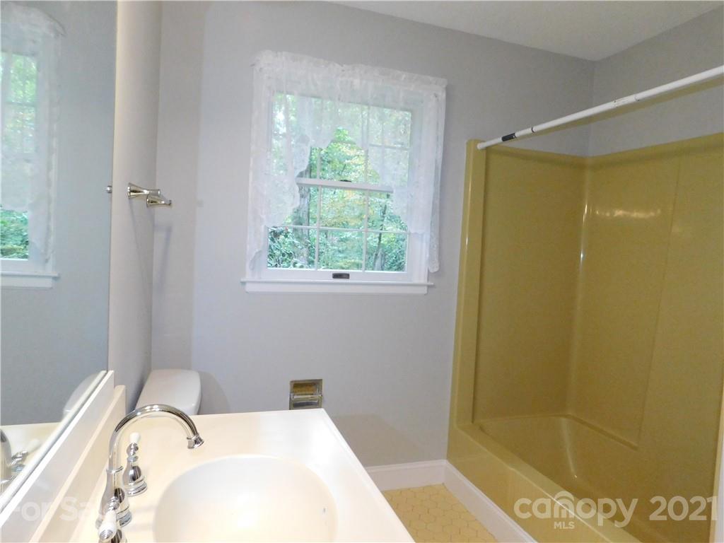2136 Sunset Road Charlotte, NC 28216 - Photo 23 of 34 a bathroom with a bathtub and shower