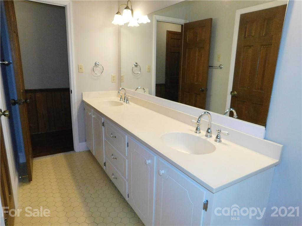 2136 Sunset Road Charlotte, NC 28216 - Photo 24 of 34 a bathroom with double vanity sinks and a mirror