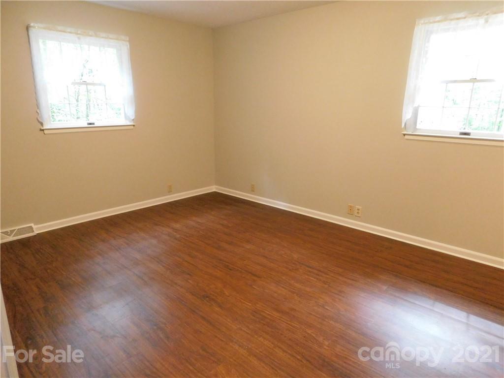 2136 Sunset Road Charlotte, NC 28216 - Photo 31 of 34 an empty room with wooden floor and windows