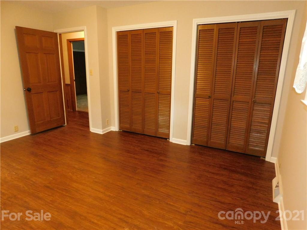 2136 Sunset Road Charlotte, NC 28216 - Photo 32 of 34 an empty room with wooden floor and closet area