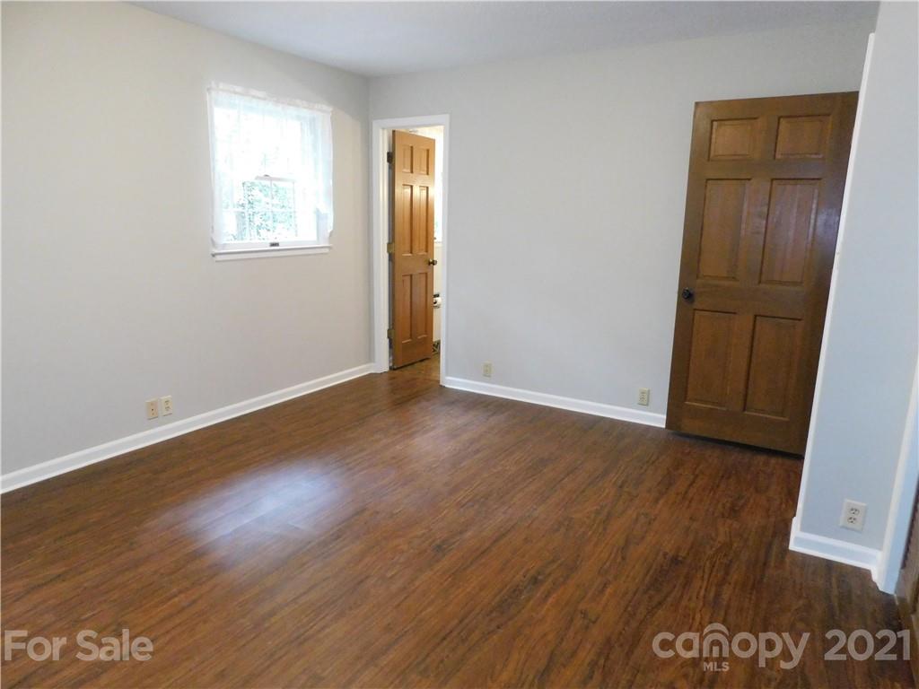 2136 Sunset Road Charlotte, NC 28216 - Photo 33 of 34 an empty room with wooden floor and windows