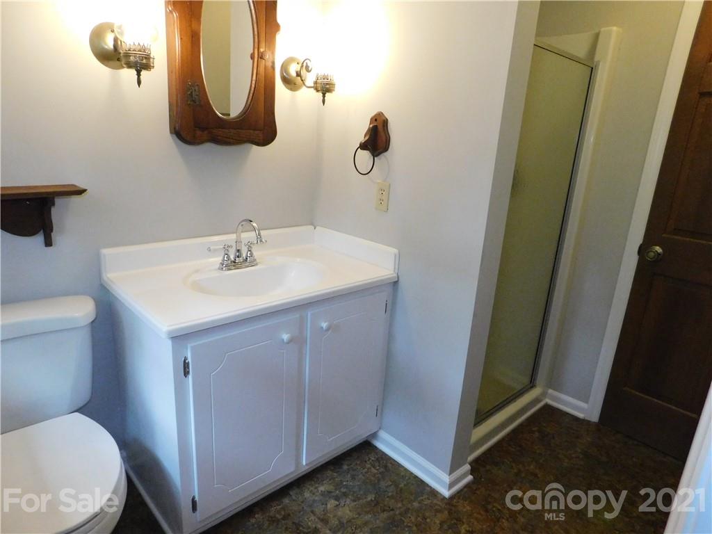 2136 Sunset Road Charlotte, NC 28216 - Photo 34 of 34 a bathroom with a sink mirror vanity and toilet