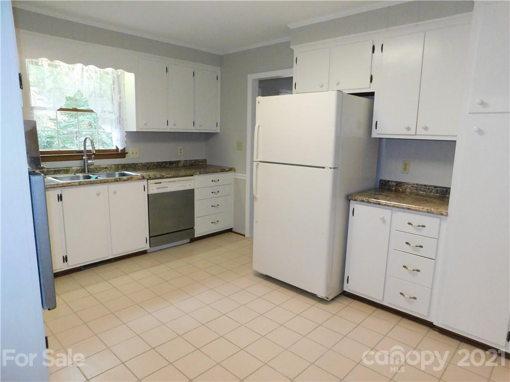 2136 Sunset Road Charlotte, NC 28216 - Photo 5 of 34 a kitchen with granite countertop cabinets appliances a sink and a window