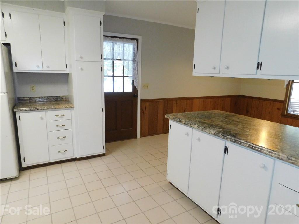2136 Sunset Road Charlotte, NC 28216 - Photo 6 of 34 a kitchen with granite countertop white cabinets and sink