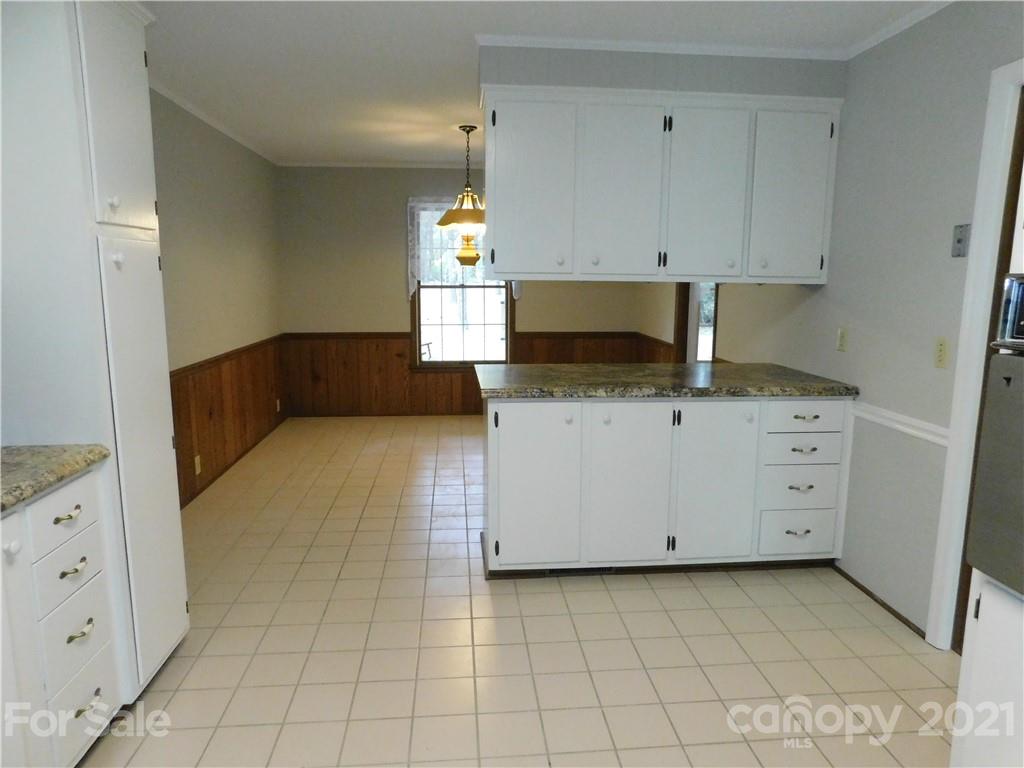 2136 Sunset Road Charlotte, NC 28216 - Photo 9 of 34 a kitchen with a cabinets and window