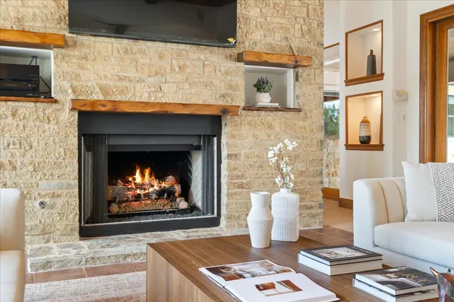 a living room with furniture a fireplace and a flat screen tv