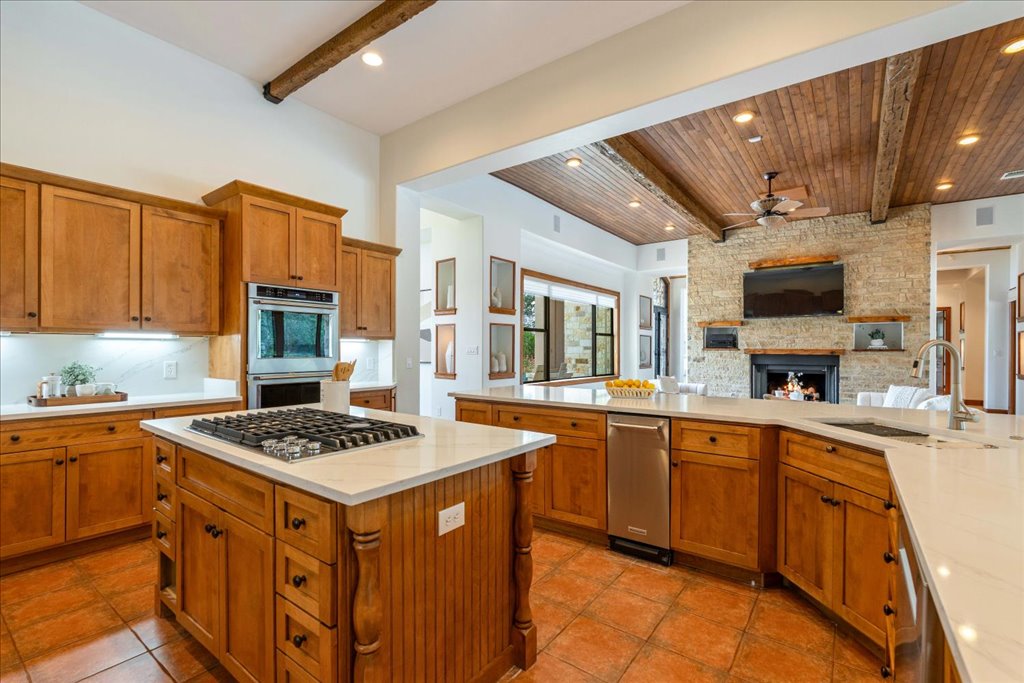 1525 Springlake Drive Dripping Springs, TX 78620 - Photo 11 of 38 a kitchen with stainless steel appliances granite countertop a sink stove and refrigerator