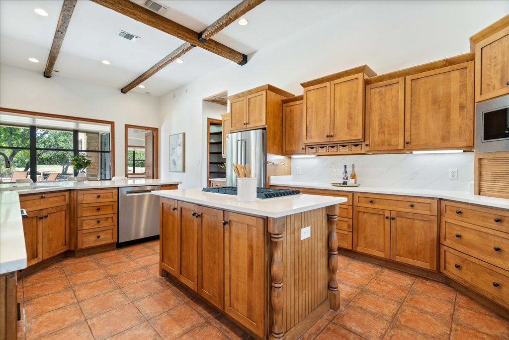 1525 Springlake Drive Dripping Springs, TX 78620 - Photo 12 of 38 a kitchen with stainless steel appliances granite countertop a sink and cabinets