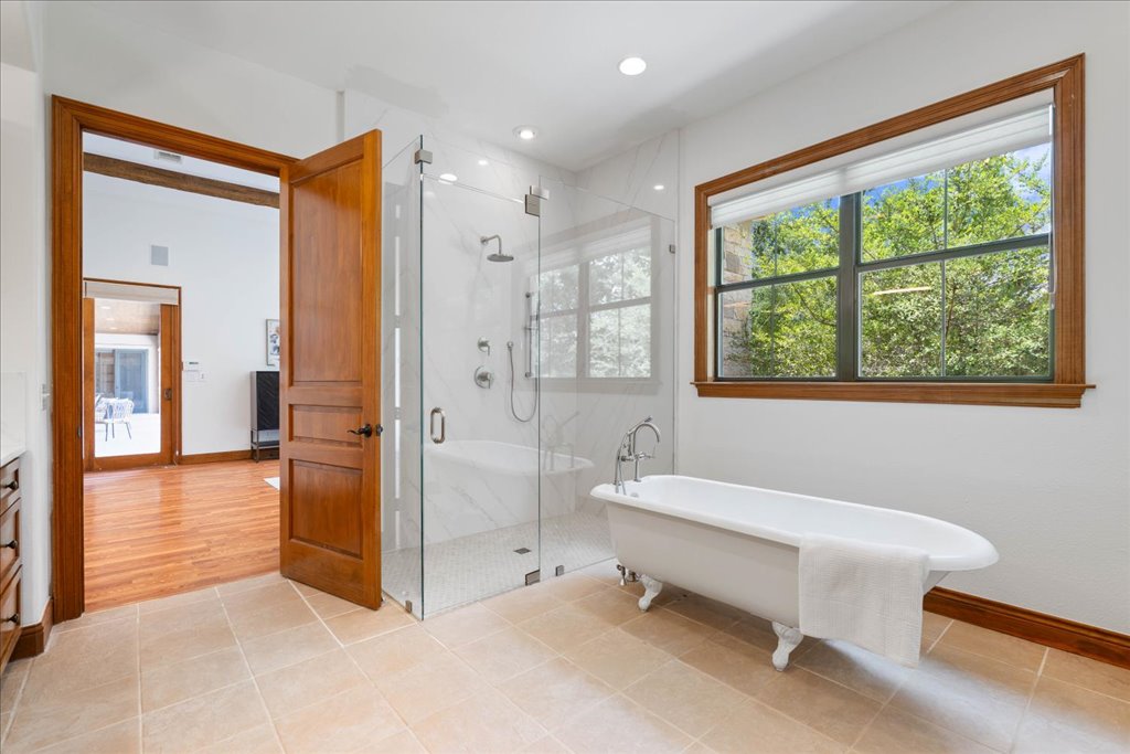 1525 Springlake Drive Dripping Springs, TX 78620 - Photo 14 of 38 a spacious bathroom with a tub and shower