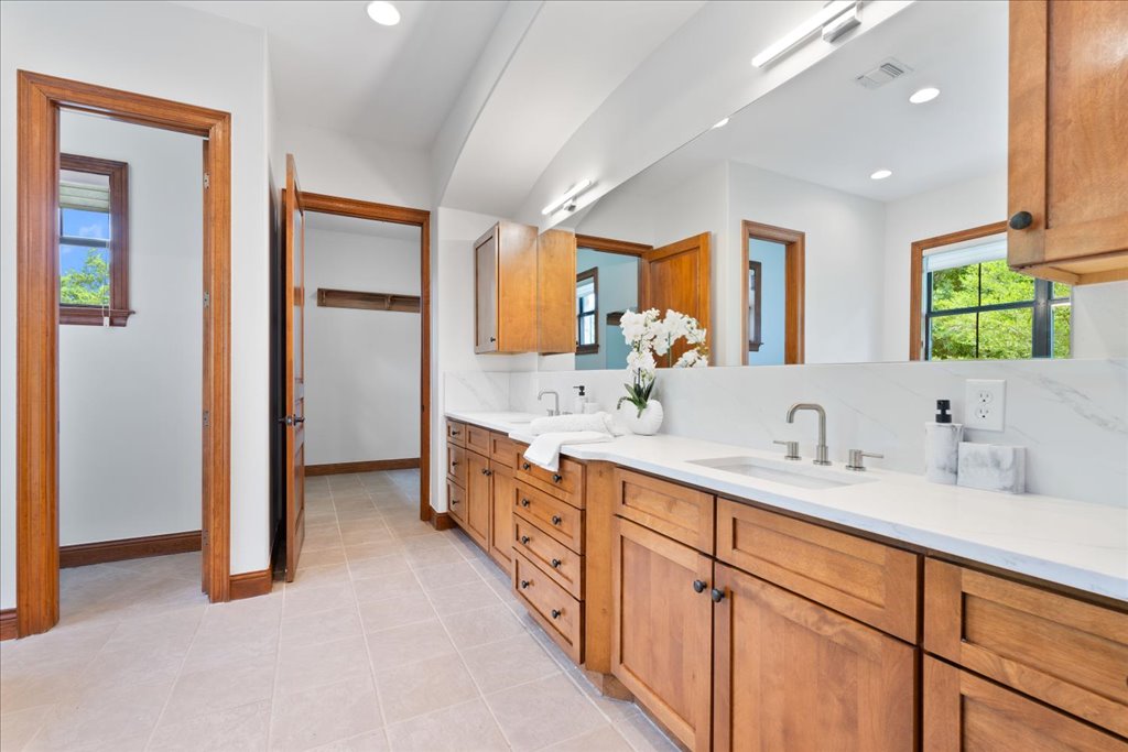 1525 Springlake Drive Dripping Springs, TX 78620 - Photo 16 of 38 a spacious bathroom with double vanity and a mirror