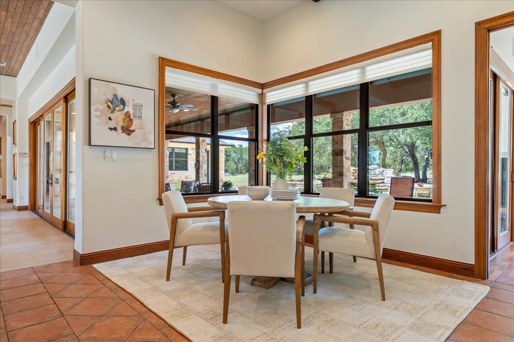 1525 Springlake Drive Dripping Springs, TX 78620 - Photo 17 of 38 a dining room with furniture and a large window