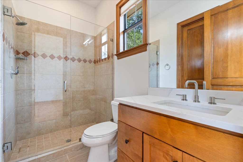 1525 Springlake Drive Dripping Springs, TX 78620 - Photo 25 of 38 a bathroom with a sink toilet and shower