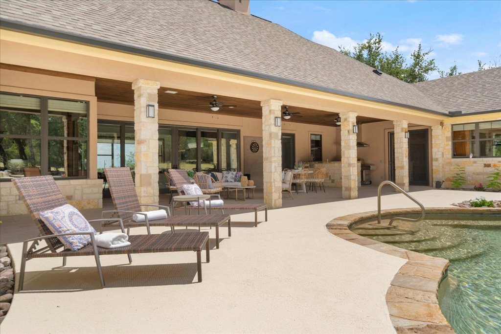 1525 Springlake Drive Dripping Springs, TX 78620 - Photo 29 of 38 a view of a patio with couches table and chairs
