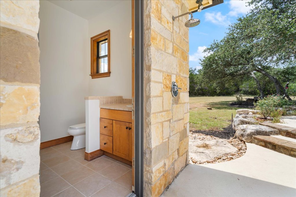 1525 Springlake Drive Dripping Springs, TX 78620 - Photo 31 of 38 a view of a bathroom with a sink and a toilet