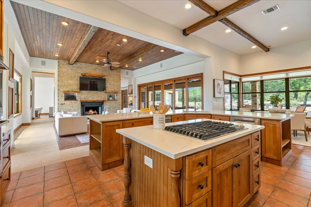 1525 Springlake Drive Dripping Springs, TX 78620 - Photo 9 of 38 a kitchen that has a lot of cabinets in it