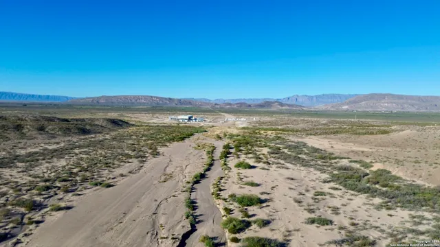 a view of an ocean beach and mountain
