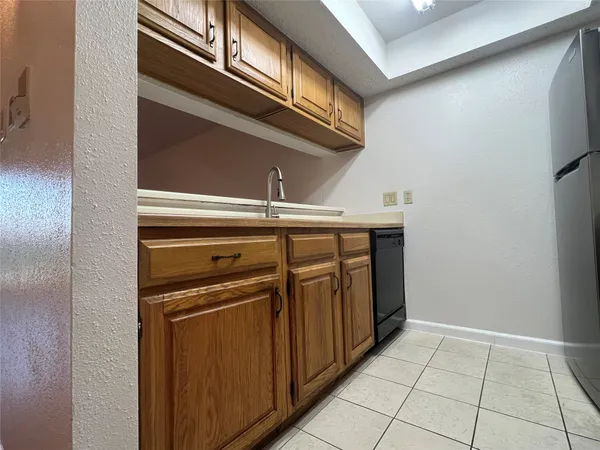 a view of a kitchen with stainless steel appliances granite countertop a refrigerator