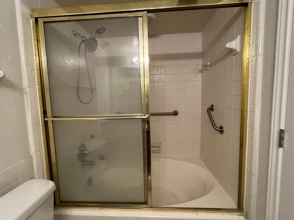 a bathroom with a glass shower door
