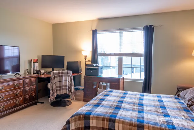 a bedroom with a bed and flat screen tv