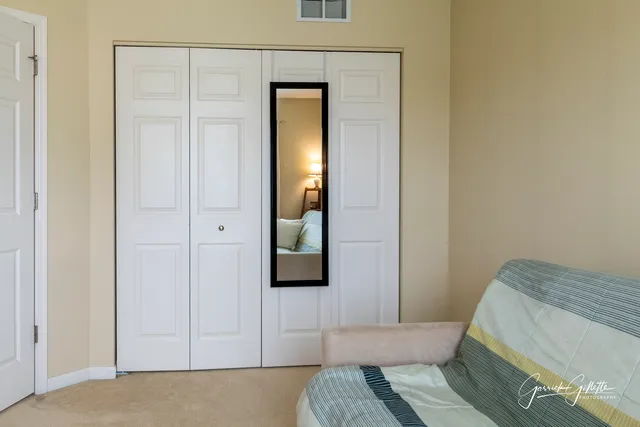 a bedroom with a bed and a mirror