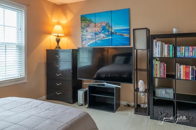 a bedroom with a bed and a book shelf