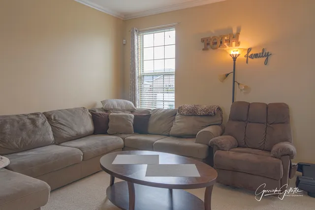 a living room with furniture a lamp and a window
