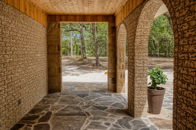 a view of a room that has a window and a potted plant