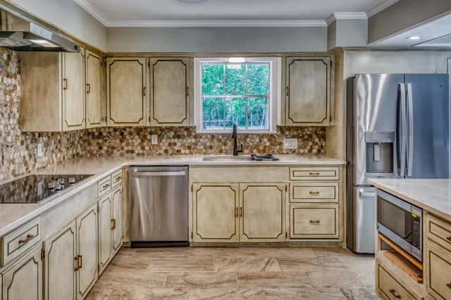 a bathroom with a double vanity sink a mirror a bathtub and window
