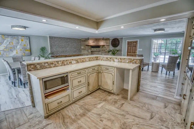 a open kitchen with stainless steel appliances granite countertop a stove top oven and cabinets