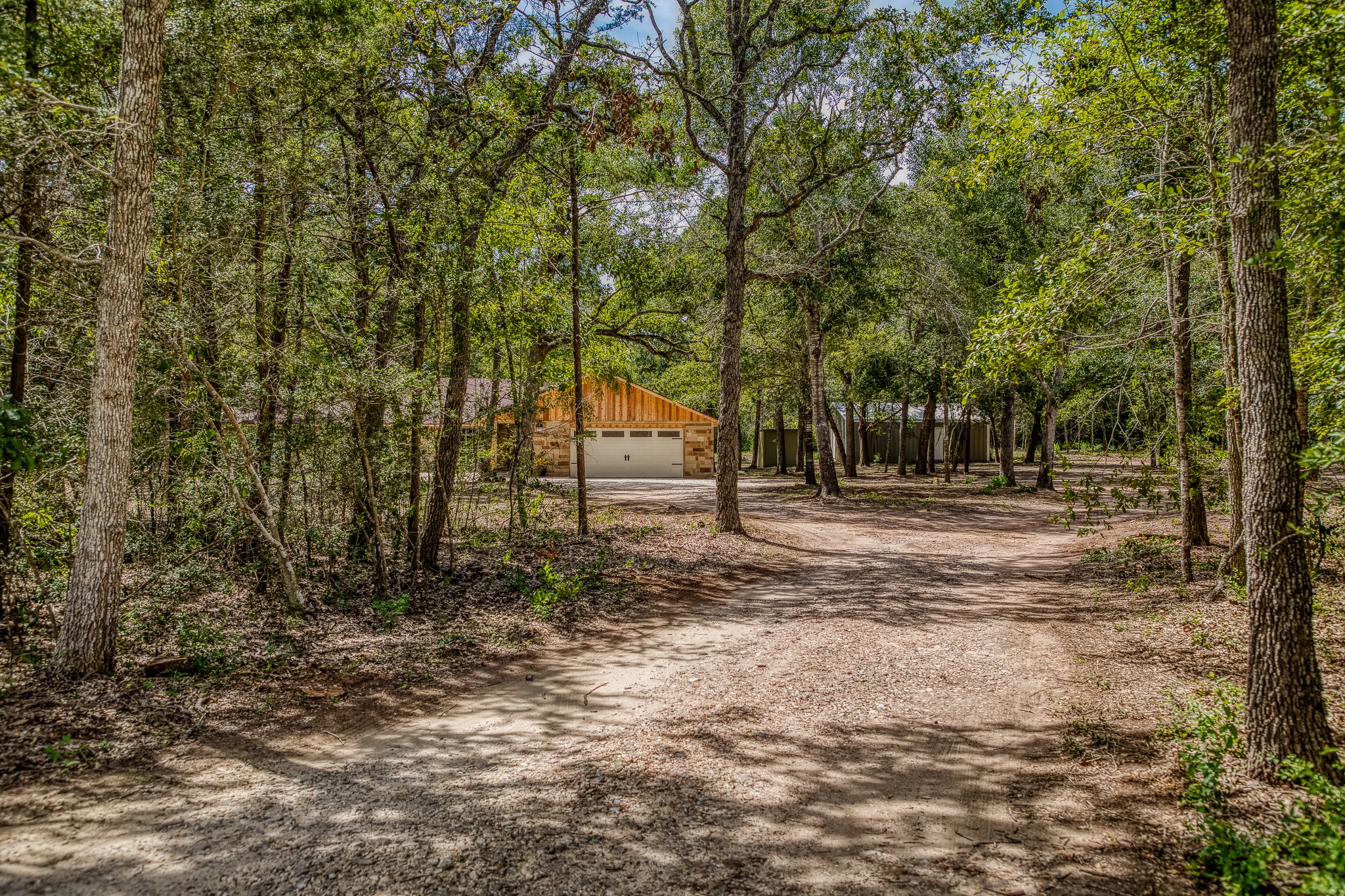 5504 Hillside Lane Brenham, TX 77833 - Photo 2 of 47 a backyard of a house with lots of trees
