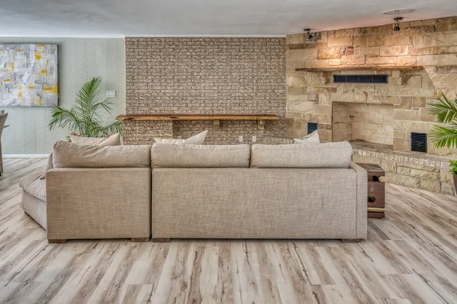 a view of a room with wooden floor and a window