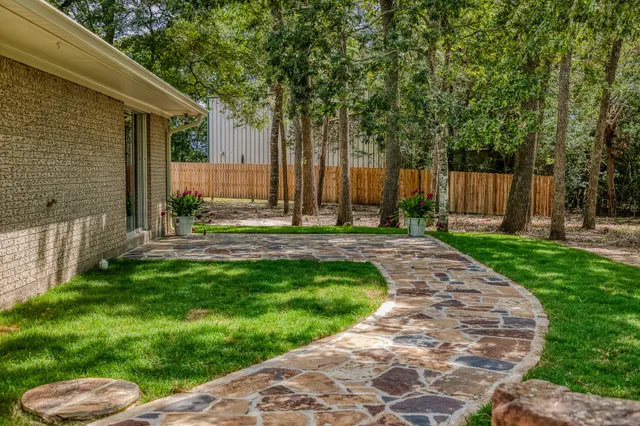 a view of house with backyard