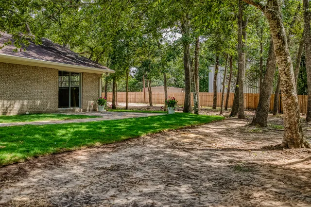a view of a chairs and table in the backyard