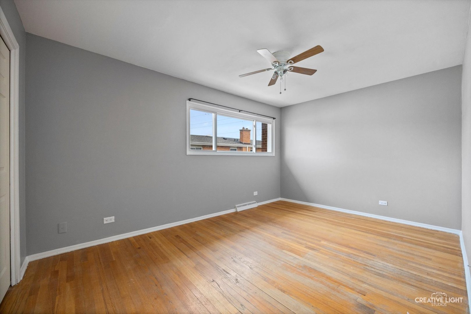 8044 West Lyons Street, Unit B Niles, IL 60714 - Photo 11 of 17 a view of a big room with wooden floor and windows