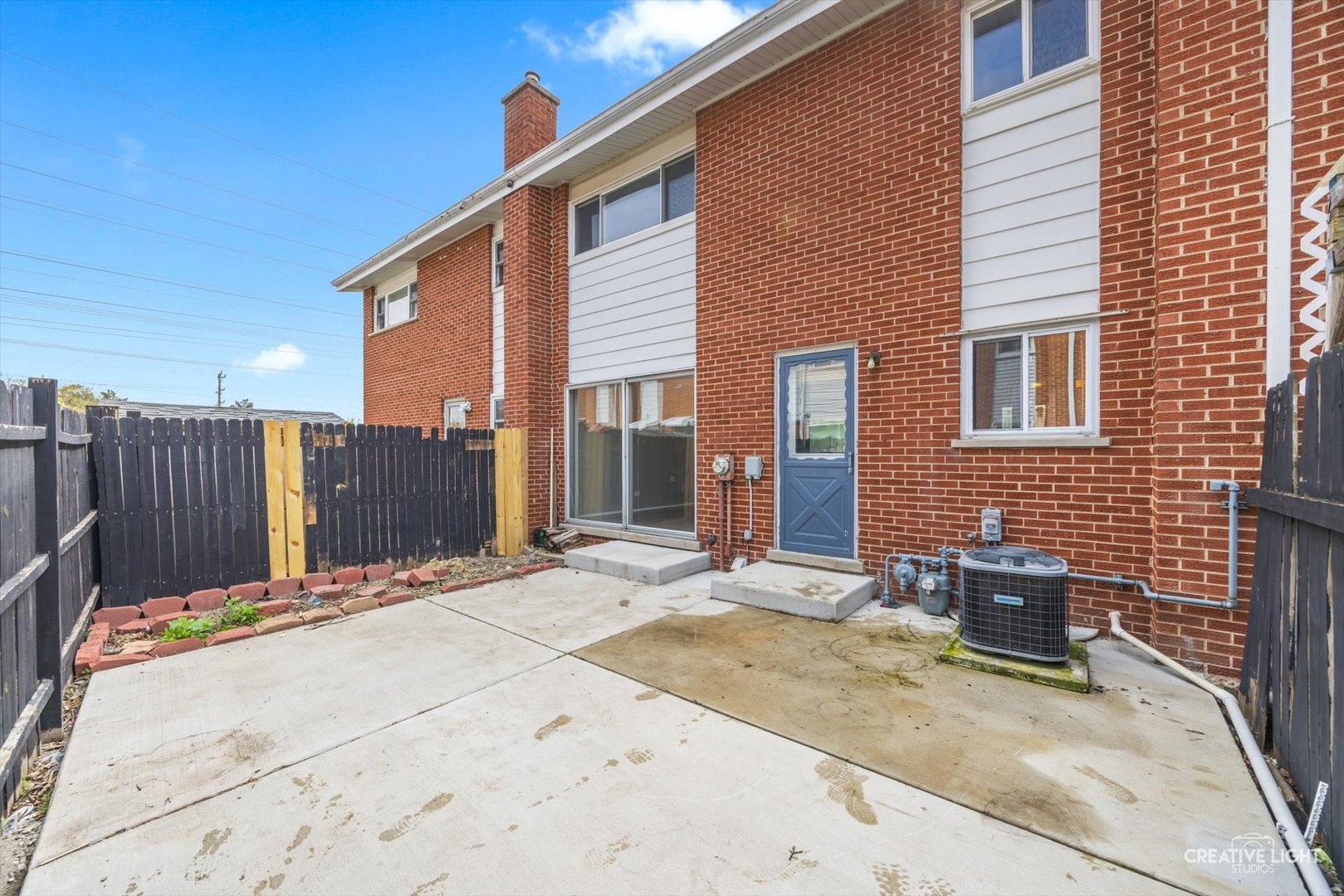 8044 West Lyons Street, Unit B Niles, IL 60714 - Photo 17 of 17 a backyard of a house with barbeque oven and brick wall