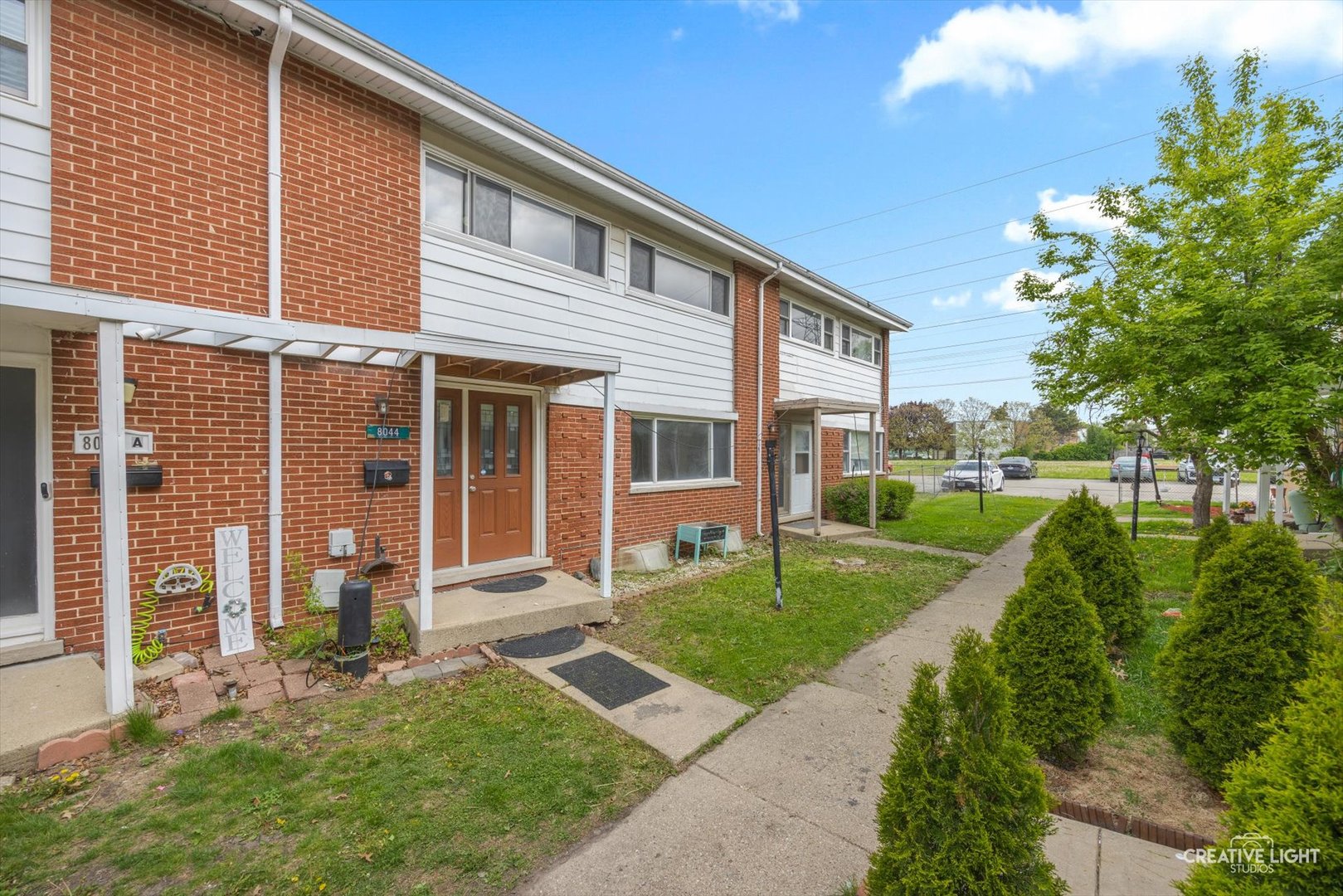 8044 West Lyons Street, Unit B Niles, IL 60714 - Photo 2 of 17 a front view of a house with a yard