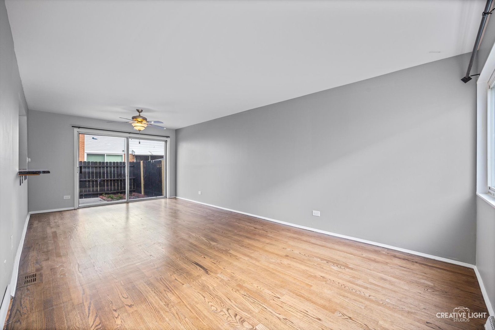 8044 West Lyons Street, Unit B Niles, IL 60714 - Photo 3 of 17 wooden floor in an empty room with a window